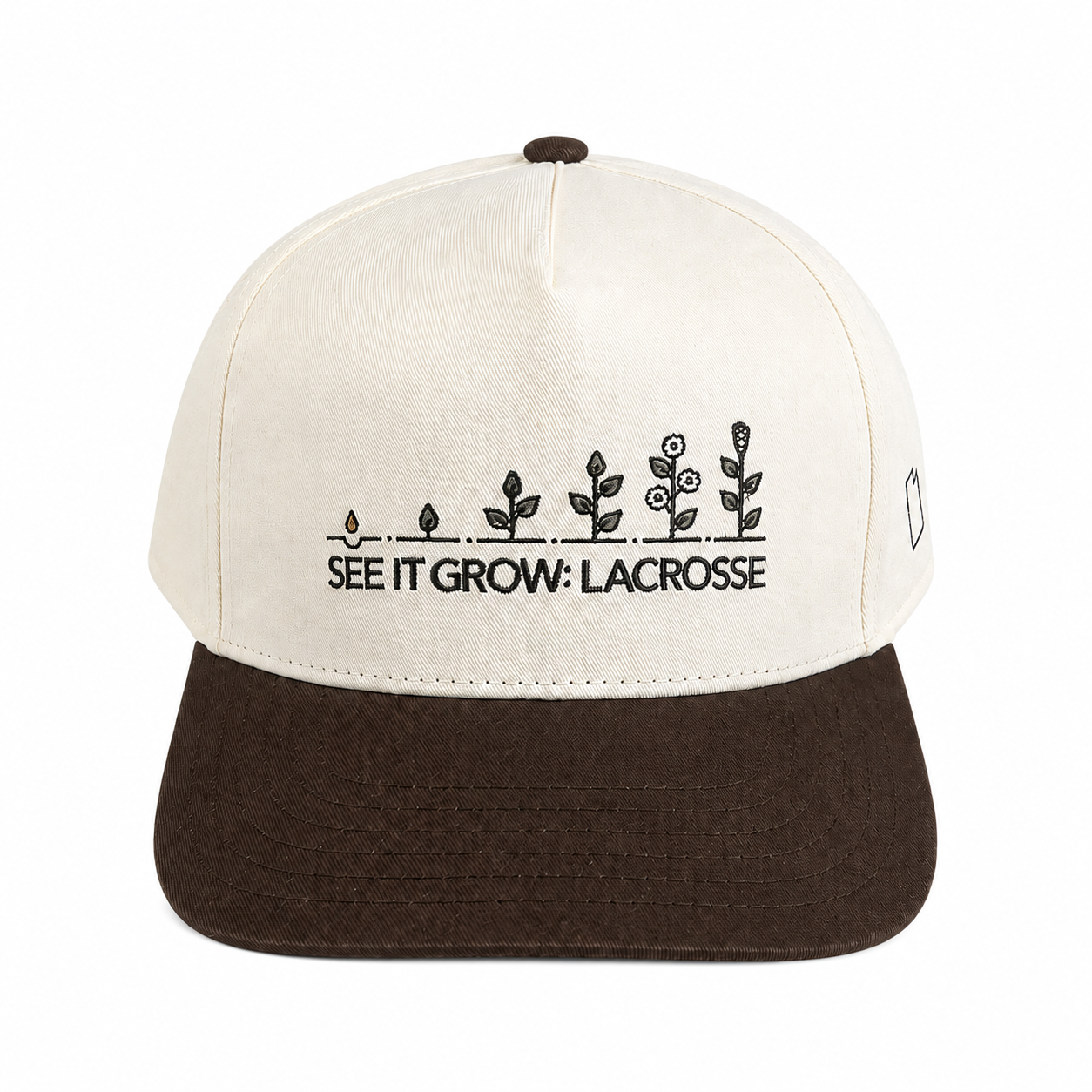 Front view of the DC Edition Desert Cream cap: cream five-panel crown with a dark brown brim and the directly embroidered See It Grow: Lacrosse seedling logo